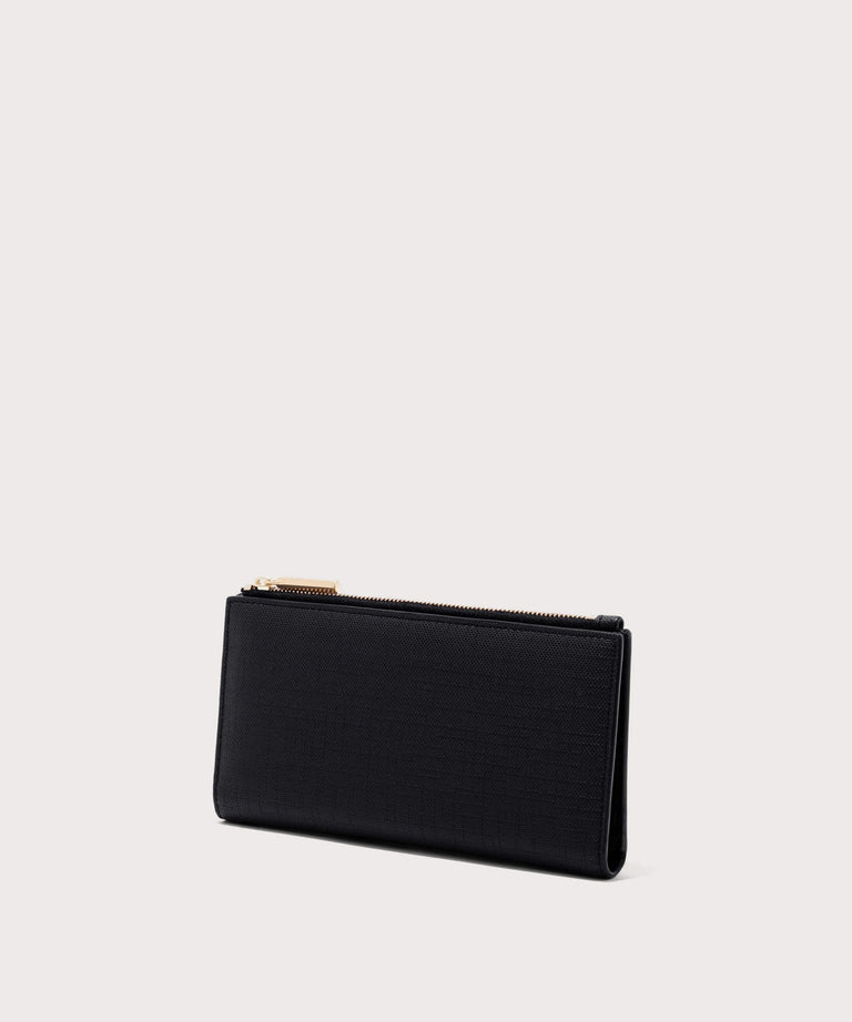 Dagne Dover Slim Wallet in black seen from an angle.
