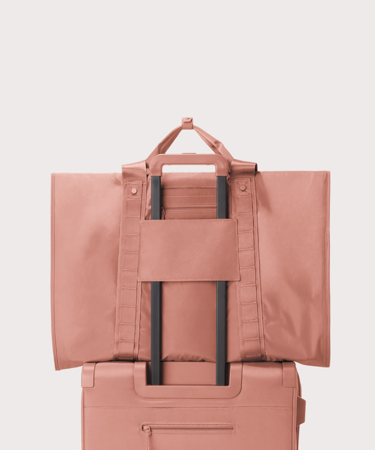 Back view of Capri garment bag in warm dust on luggage handle