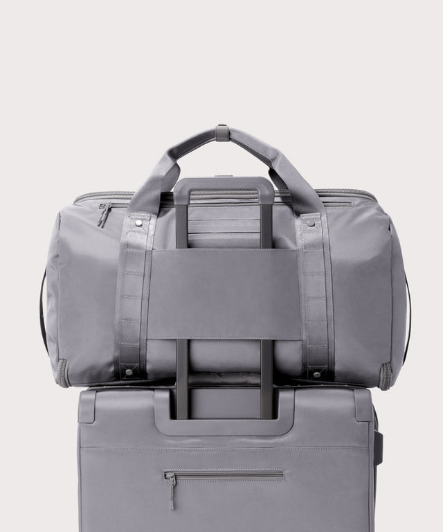 Back view of Monaco garment duffle in a light grey on luggage handle