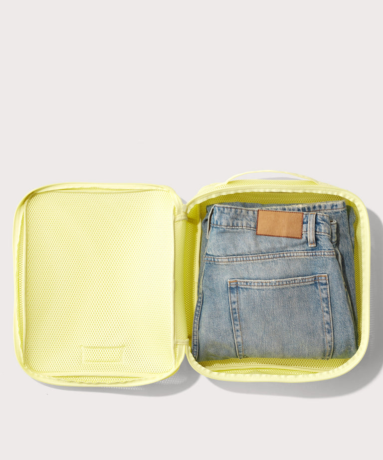 Large Roma packing cube in citrine open with jeans inside
