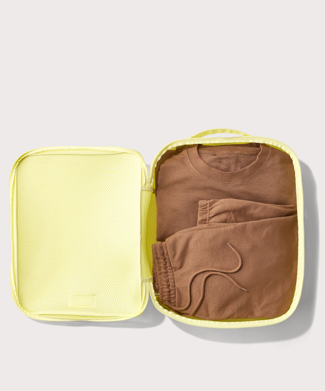 extra large Roma packing cube in citrine open with sweatsuit inside