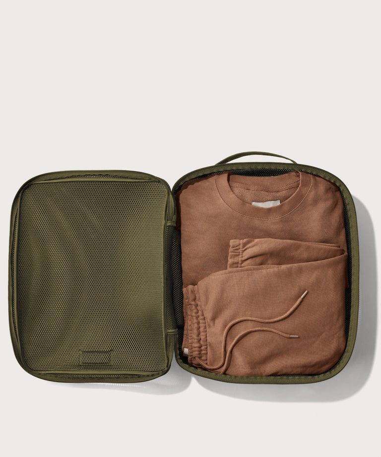 extra large Roma packing cube in dark green open with sweatsuit inside
