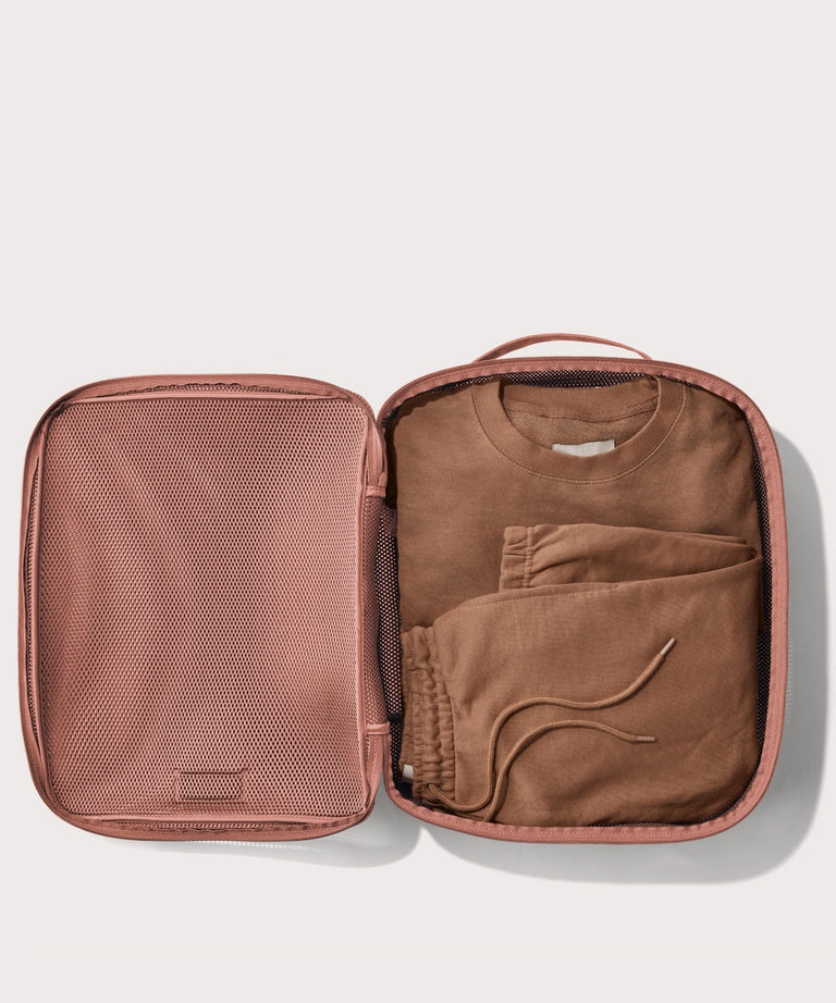 extra large Roma packing cube in warm dust pink open with sweatsuit inside