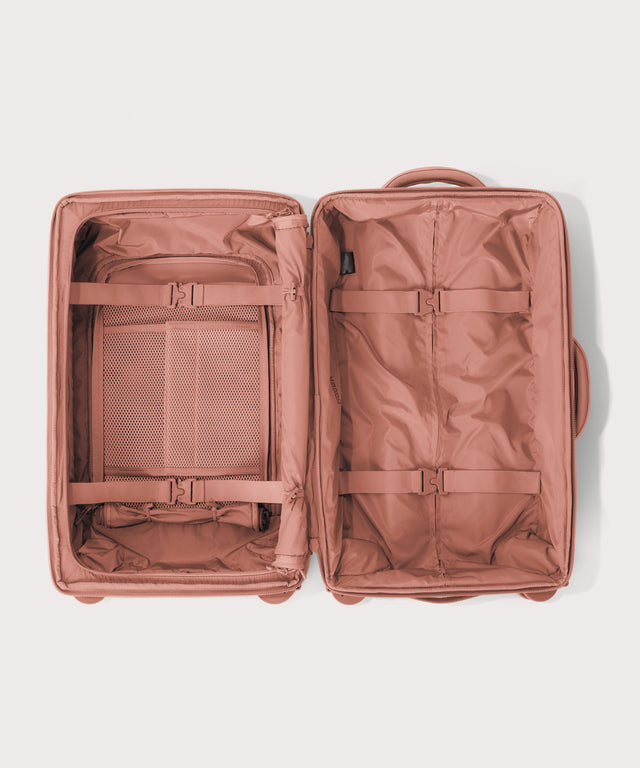 Top down of Seattle carry-on rolling luggage 23.5” in warm dust pink 
