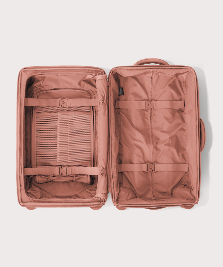 Top down of Seattle carry-on rolling luggage 23.5” in warm dust pink 
