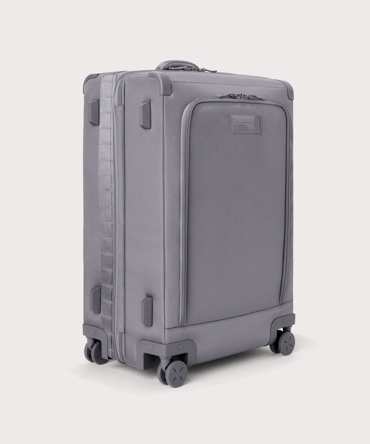 3/4 front view of Sydney checked rolling luggage 28.5” in light grey showing side luggage feet
