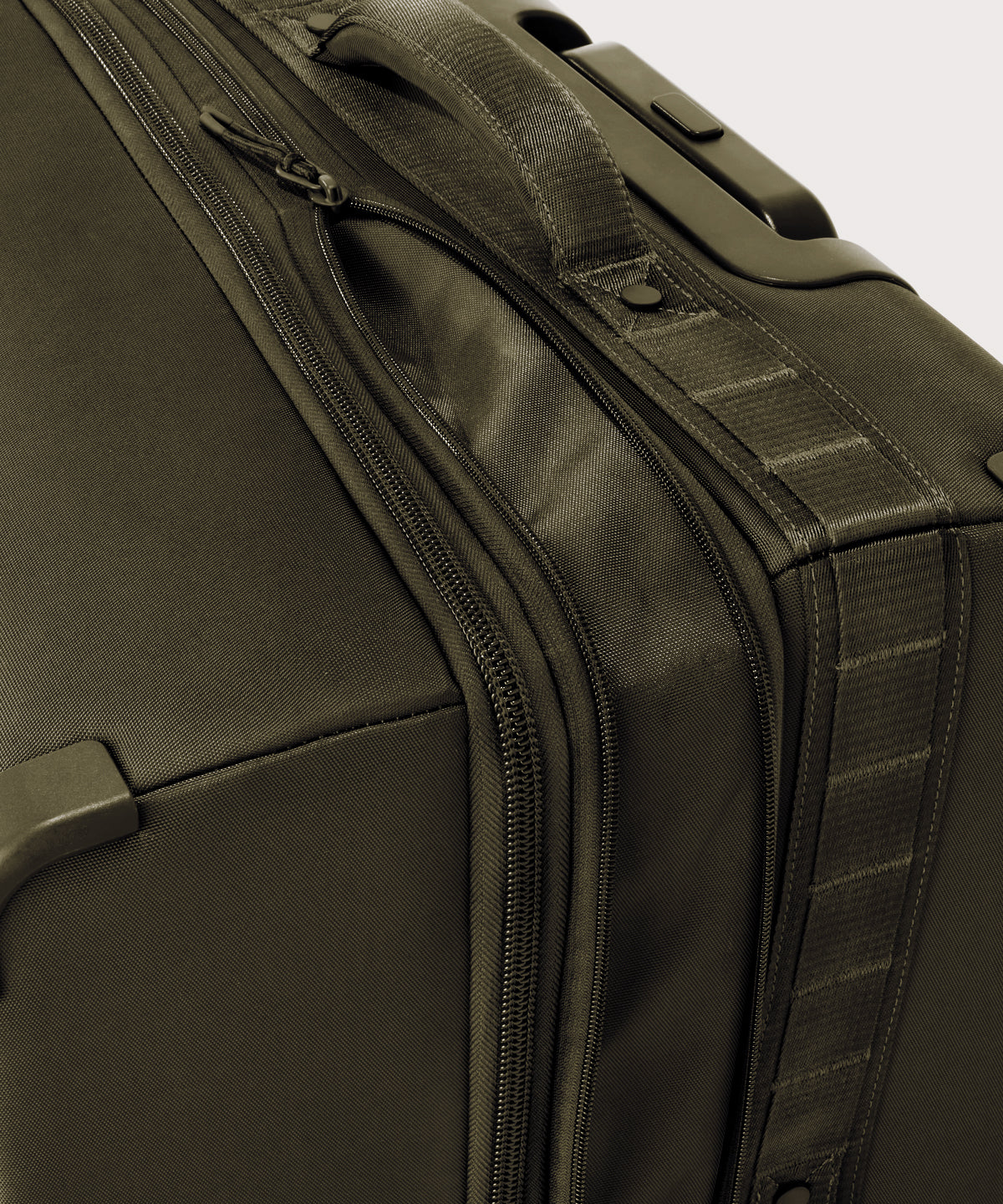 Detail shot of Sydney checked rolling luggage 28.5” in dark green expandable zipper feature
