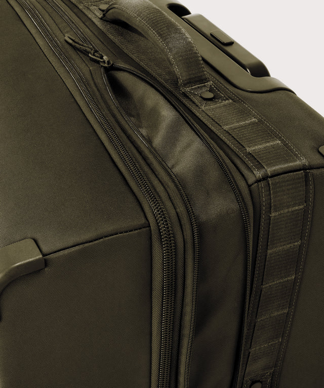Detail shot of Sydney checked rolling luggage 28.5” in dark green expandable zipper feature
