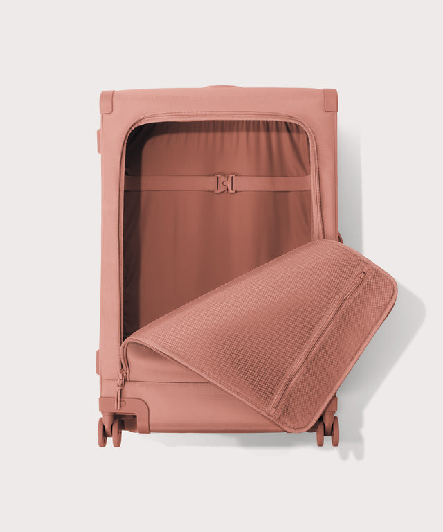 Front view of Sydney checked rolling luggage 28.5” in warm dust pink with front flap opened
