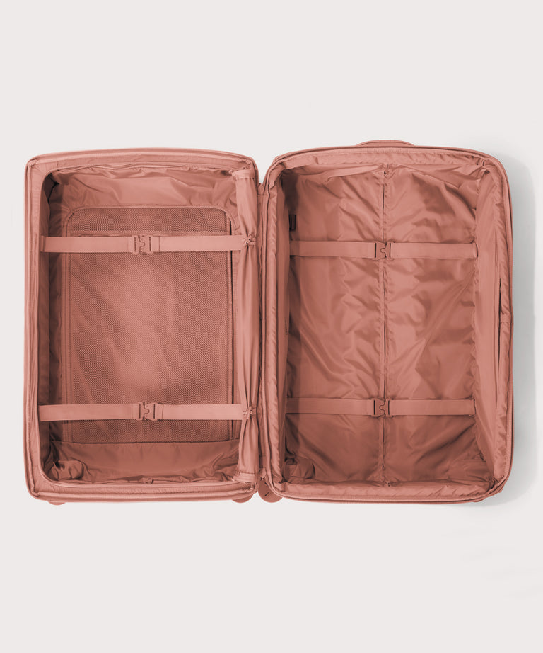 Top down of Sydney checked rolling luggage 28.5” in warm dust pink 
