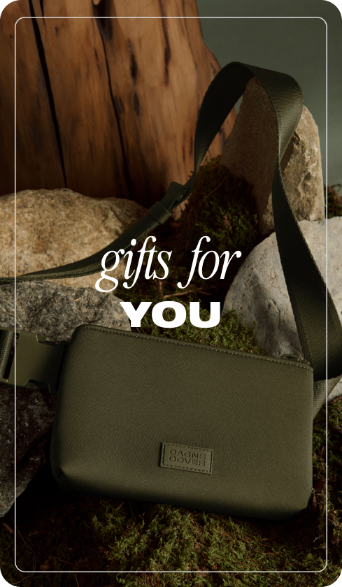 Green handbag with a visible brand logo on a natural background